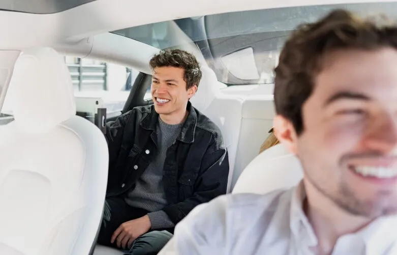 Passenger interacting with octopus tablet in the backseat of a Rideshare.